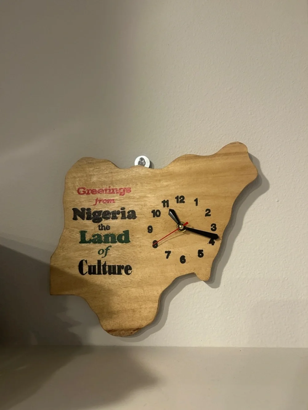 Wooden Nigeria Map Wall Clock - Natural Wood with Red, Black, Green Accents